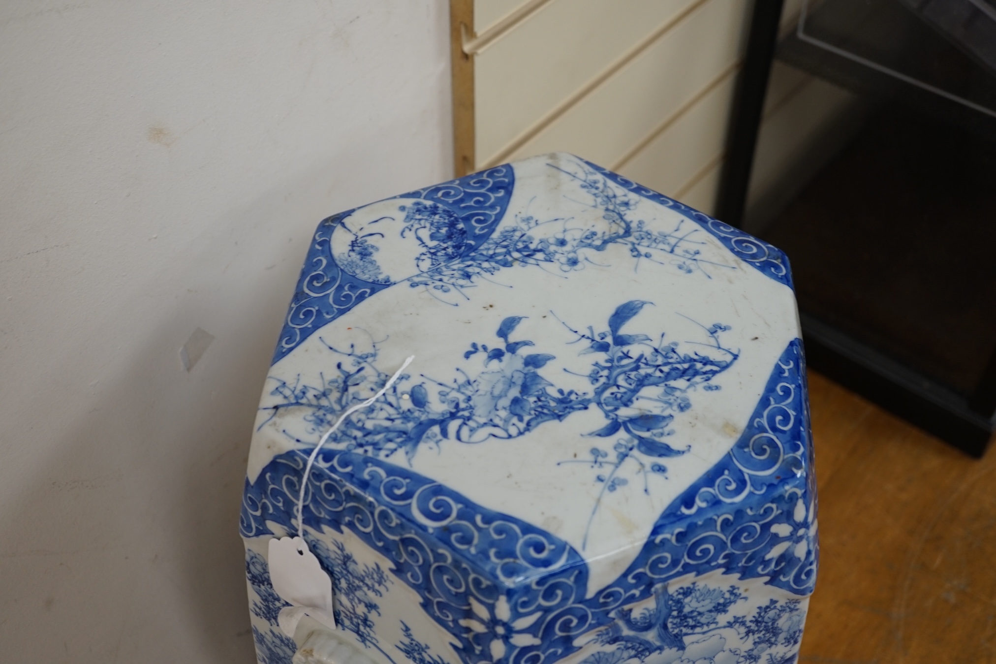 An early 20th century Japanese hexagonal blue and white porcelain garden seat, 50cm high. Condition- fair, has hairline crack